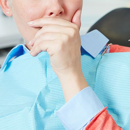 woman covering mouth